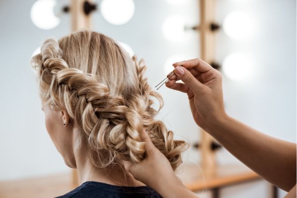 Braiding hair in a salon — hair salon SEO strategy