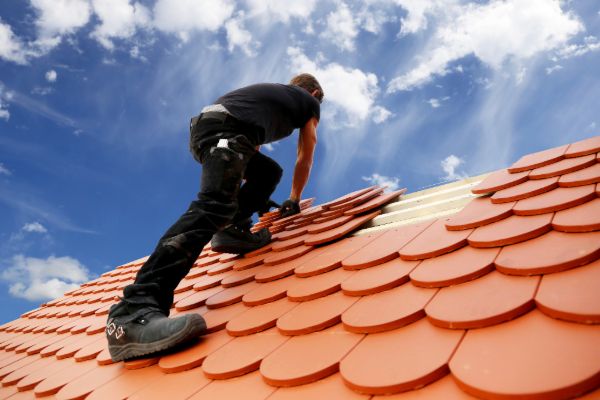 Installing clay roof tiles on a residential building
