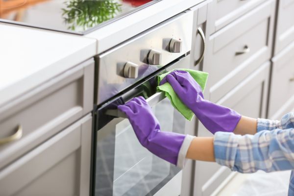 Wiping kitchen cabinets during cleaning