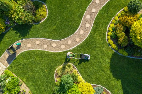 Curved walking path in a beautifully maintained green garden landscape