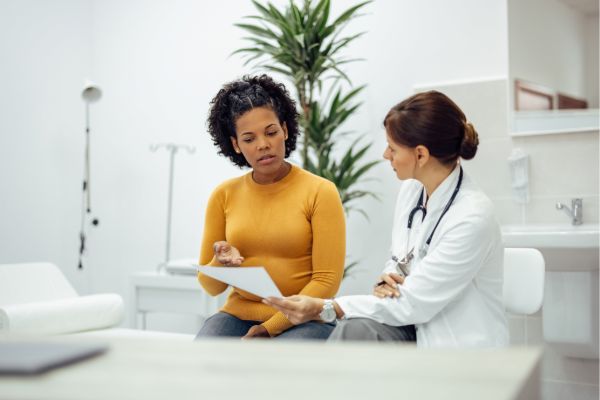 Doctor reviewing files with patient