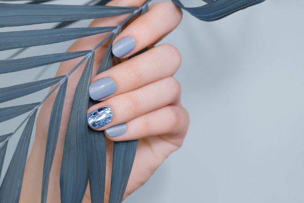 Dusty blue manicure with crystal accent nails — trending nail art style
