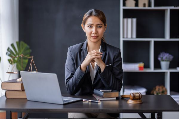 Female lawyer working on a laptop — managing digital presence across AI search platforms