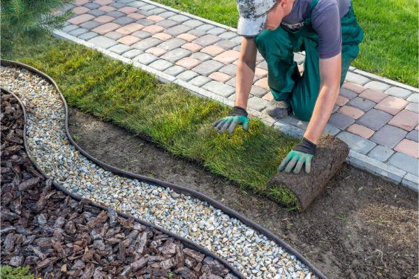 Garden pathway edging installation with curved stone border