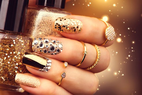 Glamorous gold glitter and rhinestone nail art design
