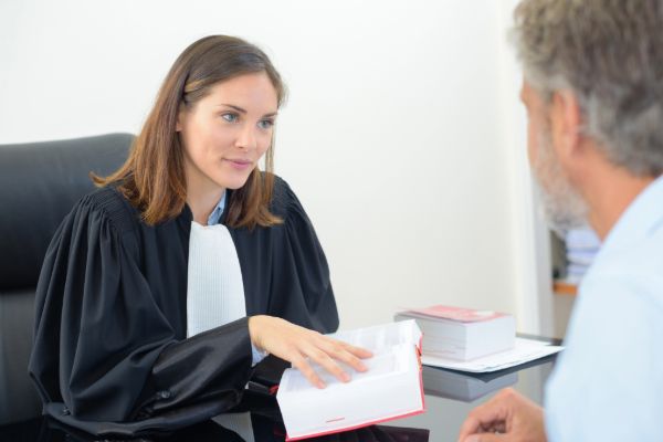 Lawyer talking with a client in an office — content builds trust before the first meeting