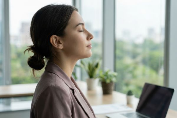 woman practicing mindfulness and breathing exercise for stress relief
