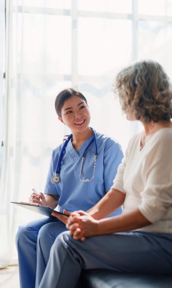 Healthcare worker listening to senior patient