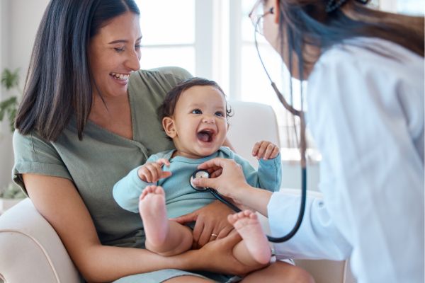 Pediatrician examining baby