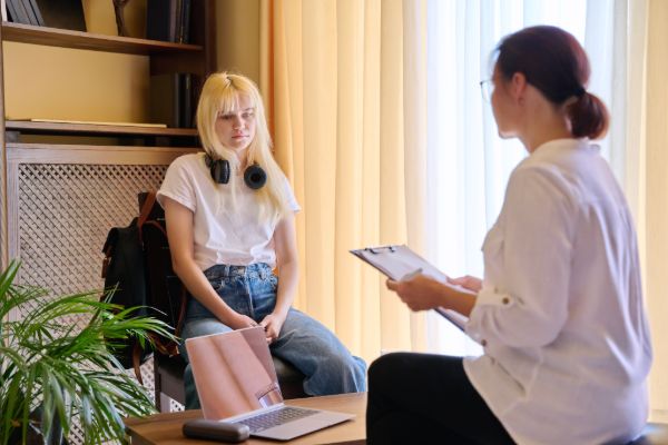 therapist counseling a teenage girl during session