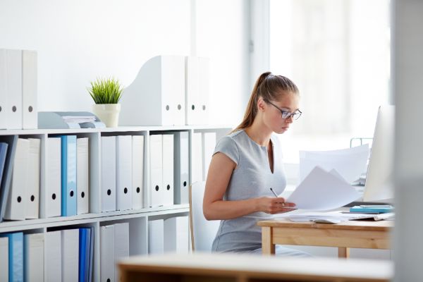Accountant organizing files in office