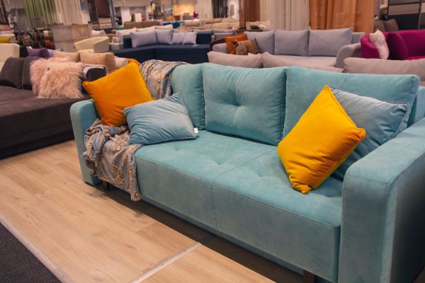 Blue sofa with yellow cushions in a furniture showroom