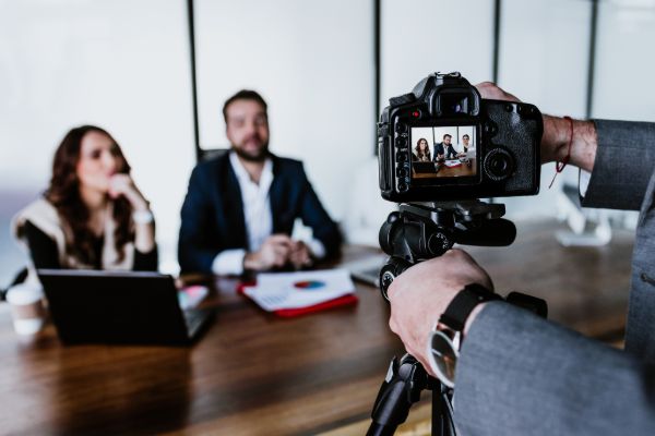 Corporate photographer shooting business meeting scene