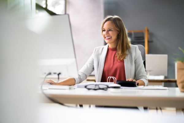 Certified public accountant working on laptop at office desk
