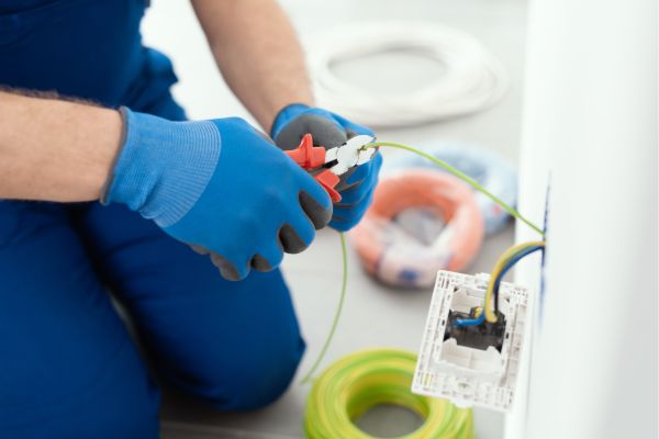 electrician cutting wires during electrical installation