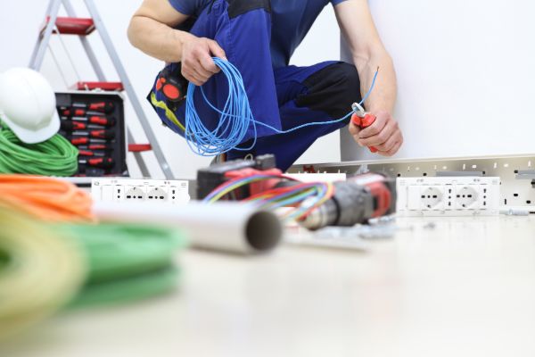 electrician repairing electrical system with tools