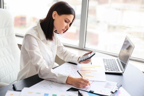 Accountant writing financial report at desk
