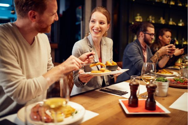 group of people enjoying food together at a restaurant