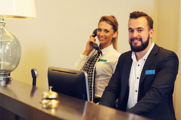 Hotel reception staff welcoming guests
