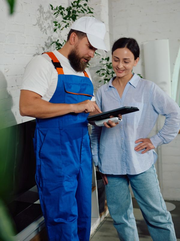 HVAC technician explaining service details to homeowner during consultation