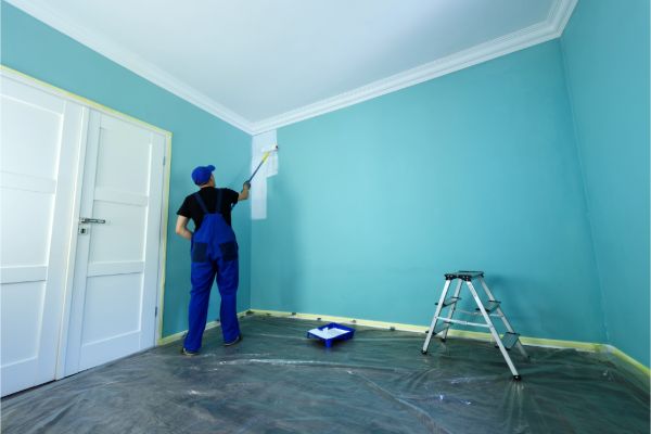 Interior painting contractor working on a room