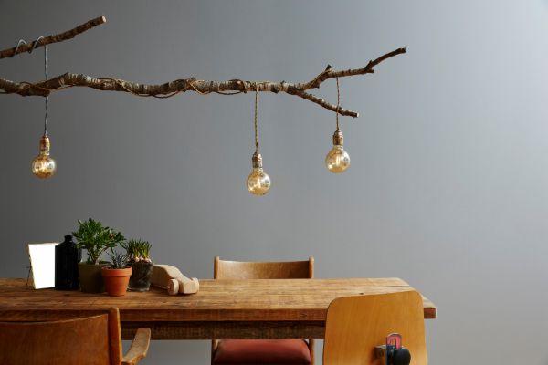 Modern dining room interior decor with hanging lights and wooden table