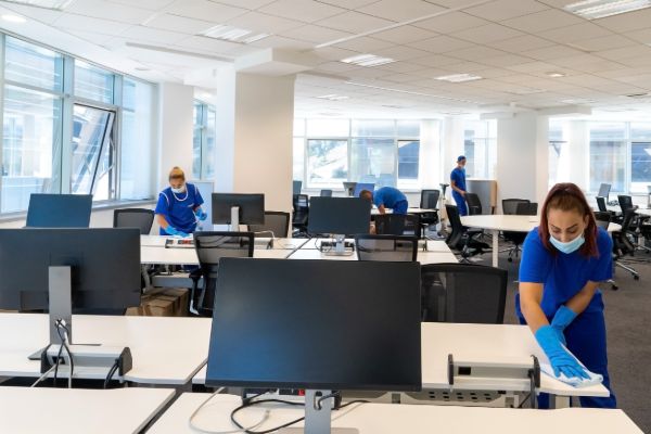 Cleaning staff working in modern office space