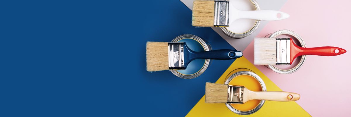 Painting tools including brushes, rollers, and supplies on a clean background