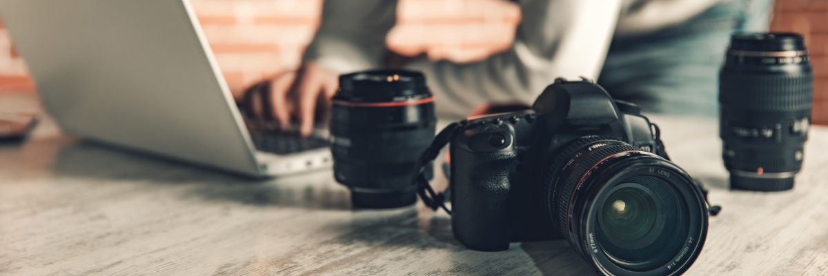 Photographer transferring photos in laptop after photography session