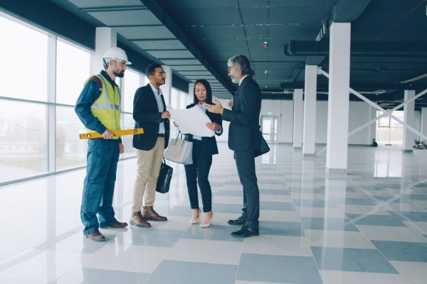 property management team discussing plans inside a commercial space