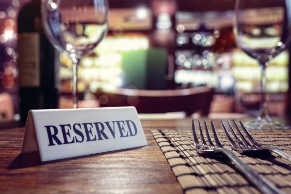 reserved sign placed on a dining table in a restaurant