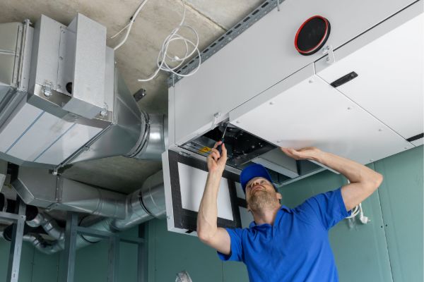 HVAC technician performing repair and maintenance service