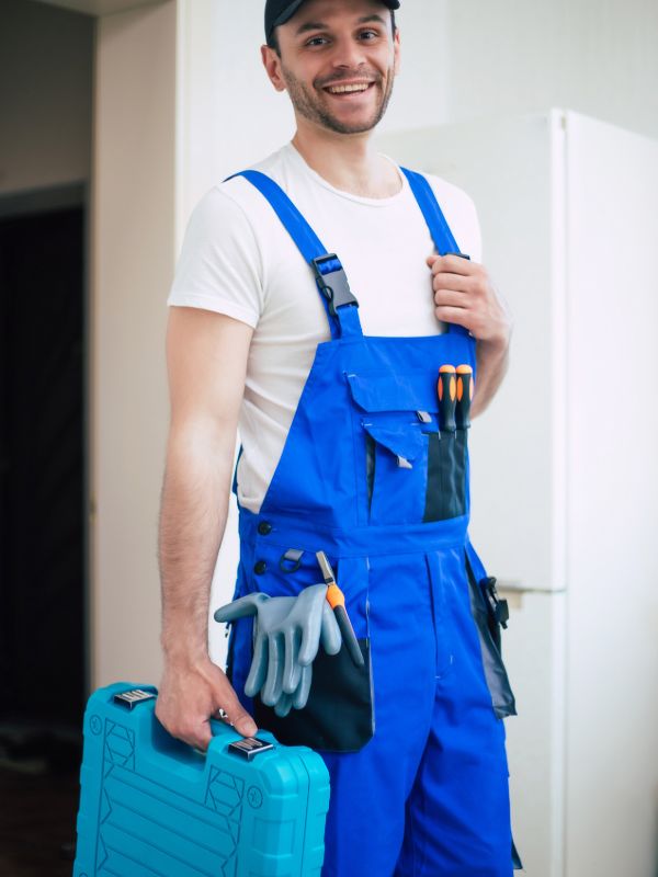 Appliance repair technician holding tools
