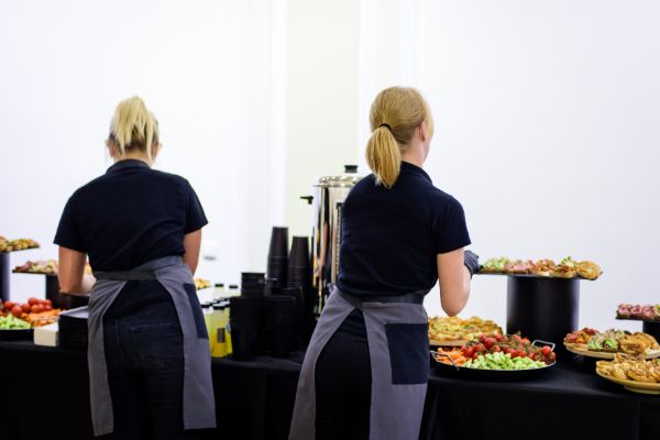 Catering staff preparing food service at an indoor event