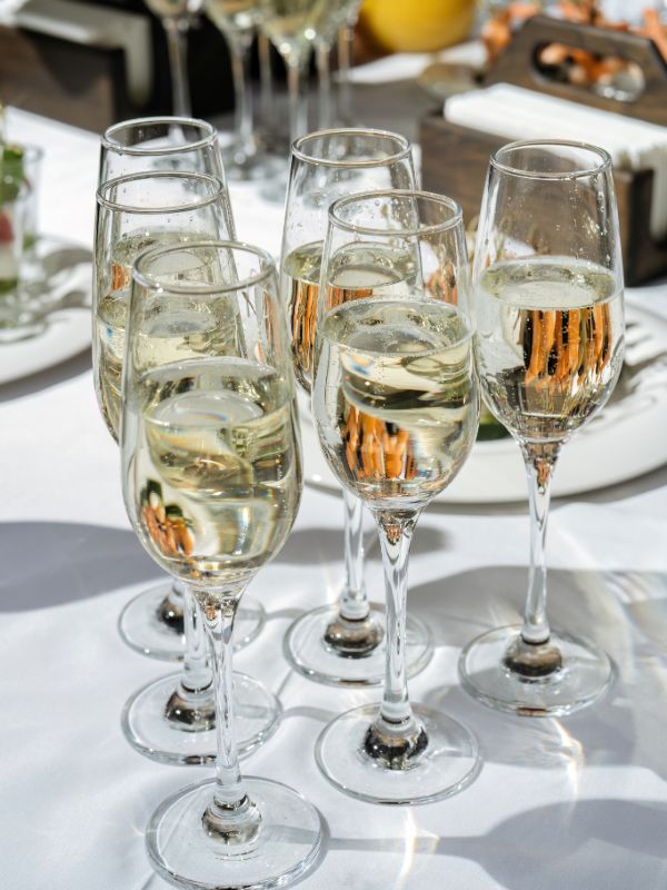 Champagne glasses arranged on a catering event table
