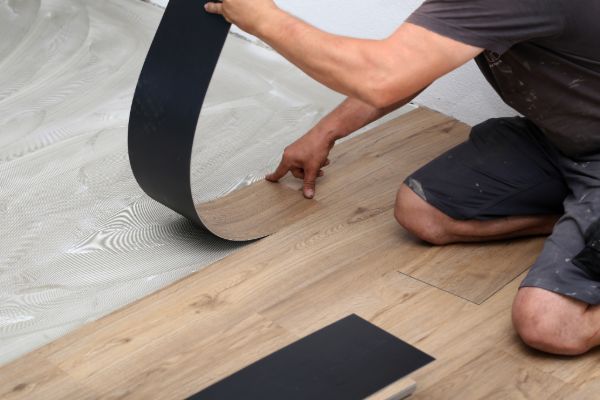 Installing floor underlayment before hardwood flooring installation