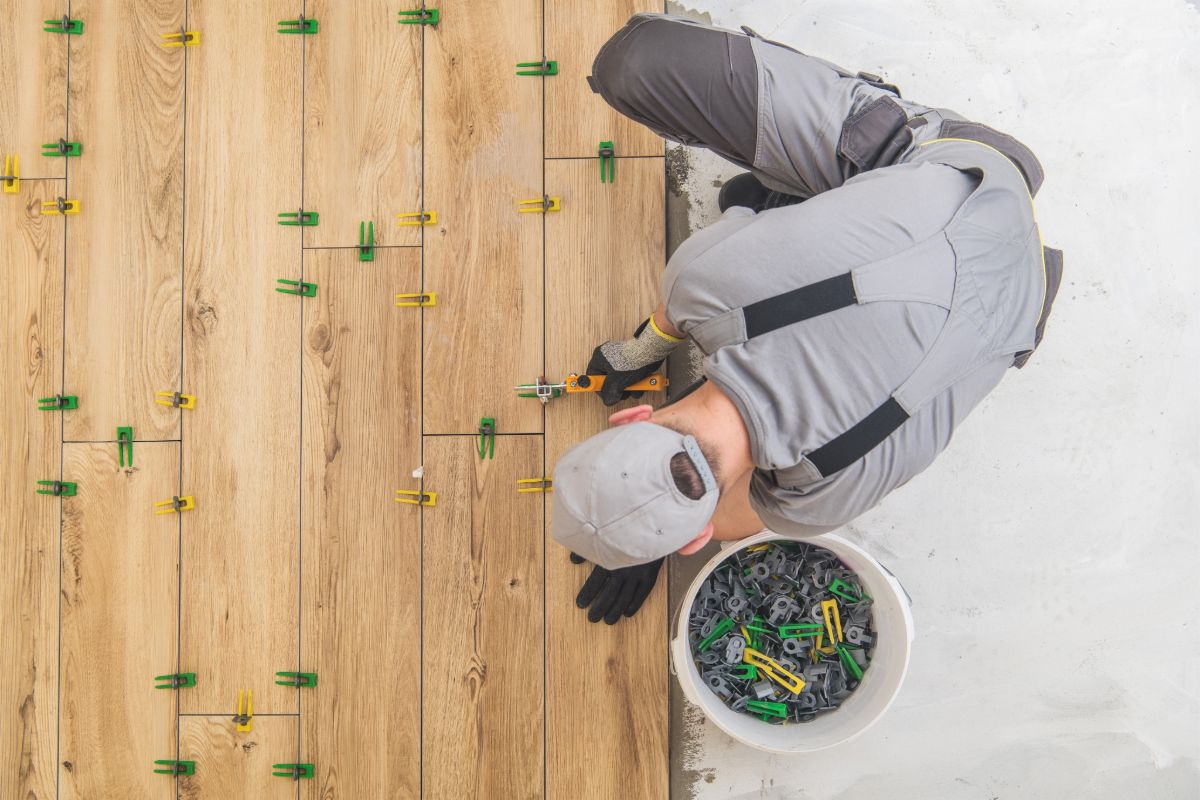 Contractor installing hardwood flooring in a residential space
