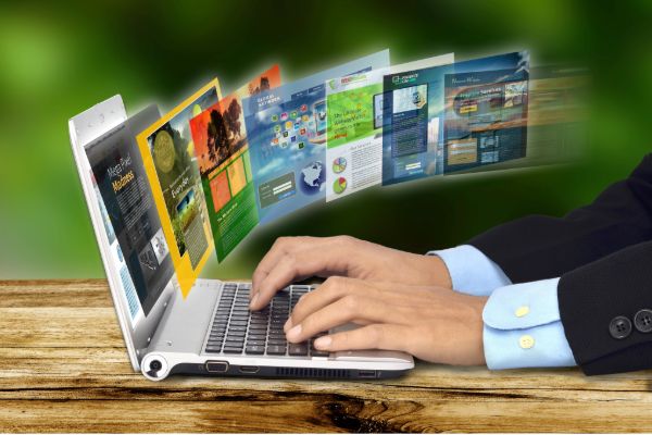 Laptop showing multiple professional website designs across different industries