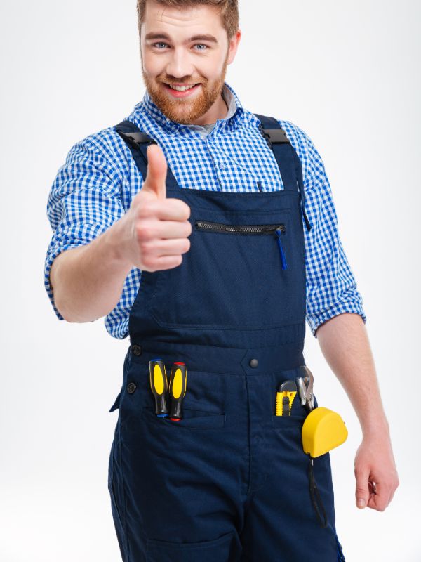 Locksmith technician wearing work uniform and standing with tools