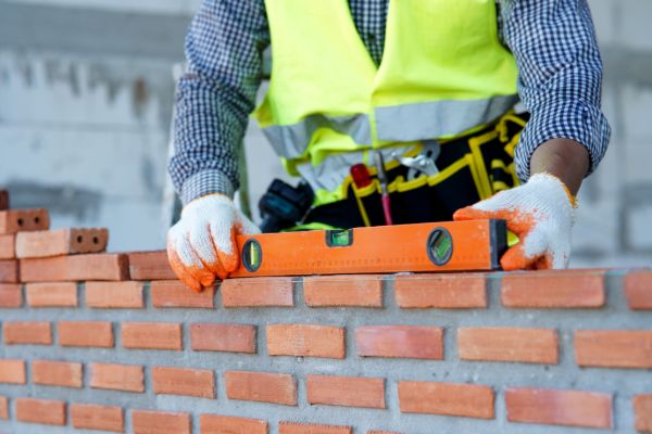 Mason building a brick wall during residential construction