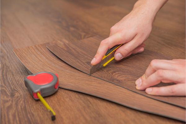 Measuring and cutting hardwood flooring planks for installation