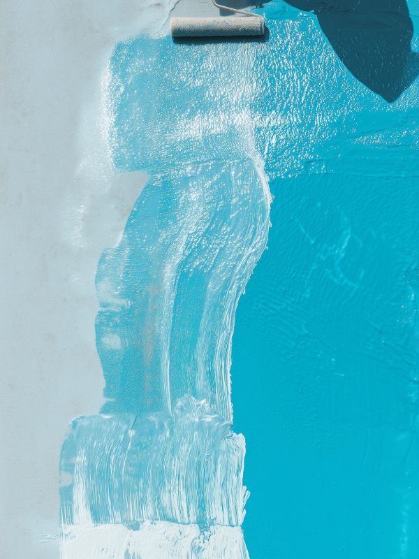 Swimming pool waterfall feature with flowing water in a luxury pool design