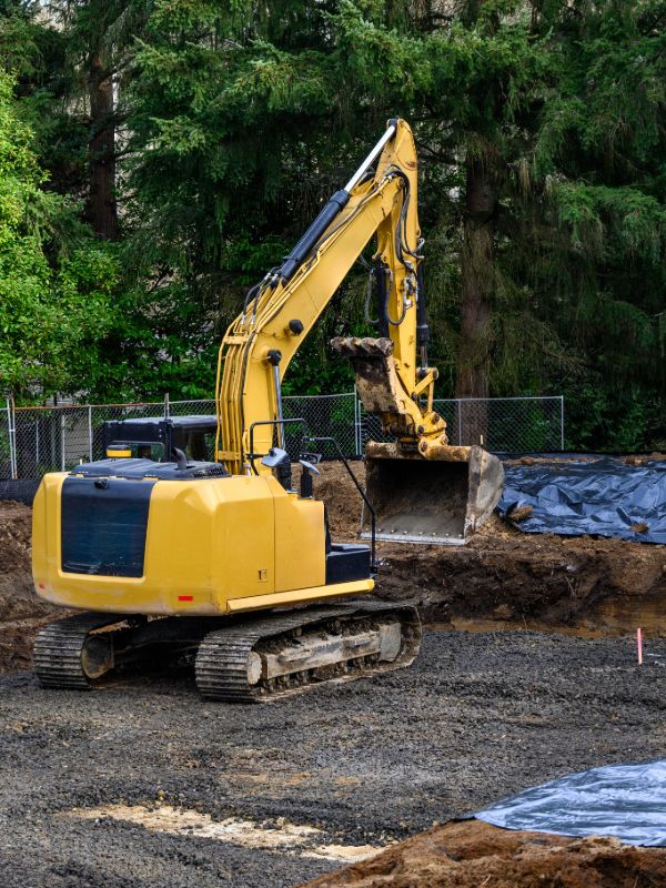Excavator working on residential construction site foundation