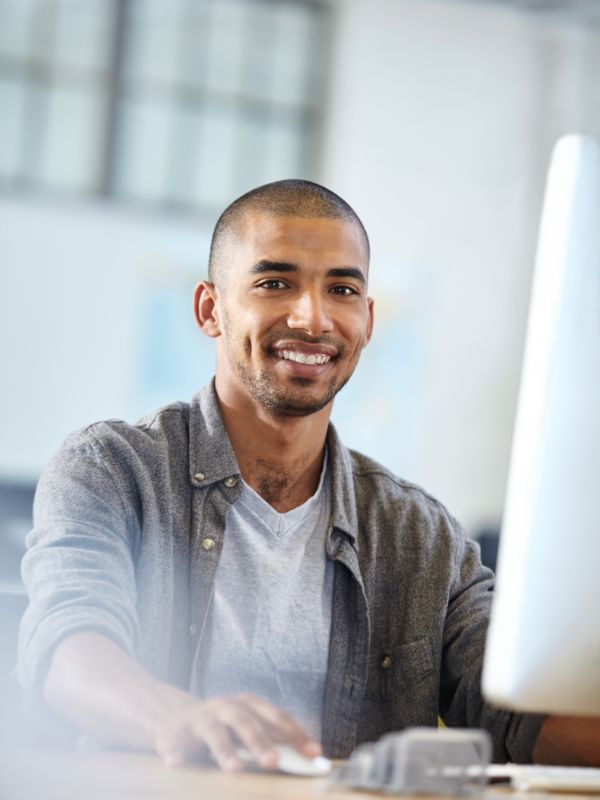 Website designer designing a modern website on desktop in an office