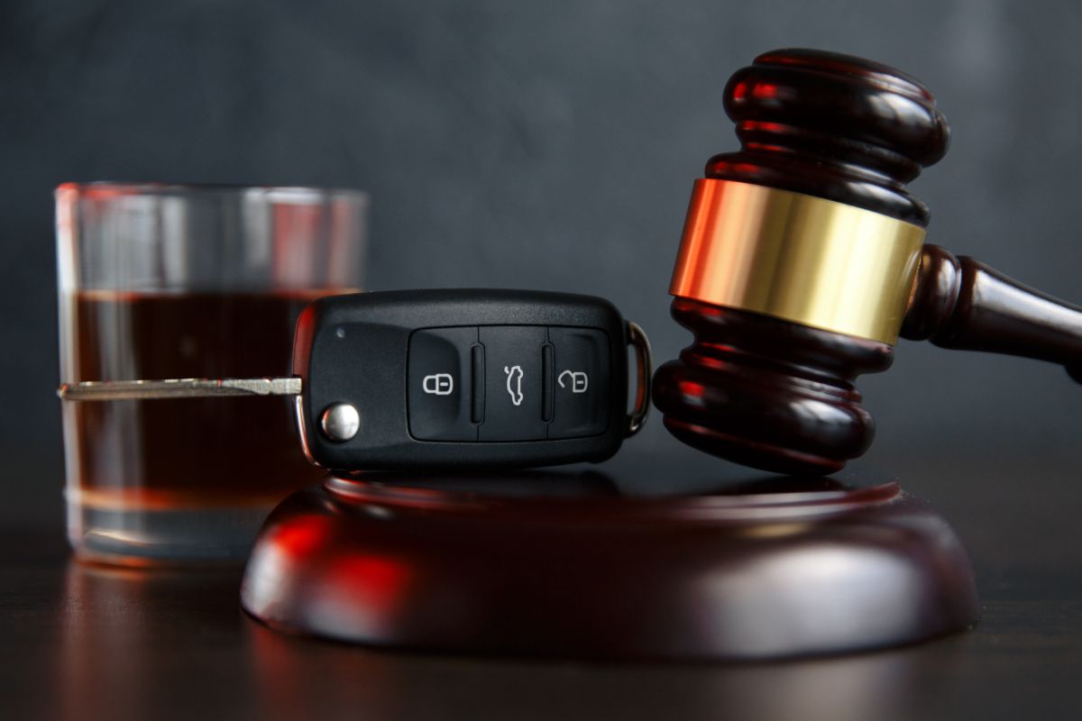 DUI defense attorney services with legal gavel, vehicle keys, and alcohol evidence