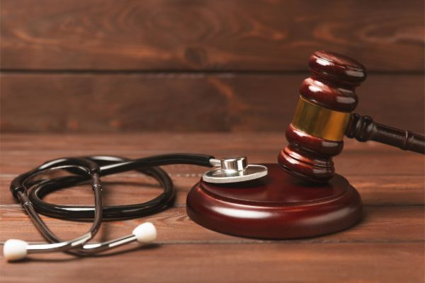 Medical malpractice lawyer consultation with legal and healthcare symbols