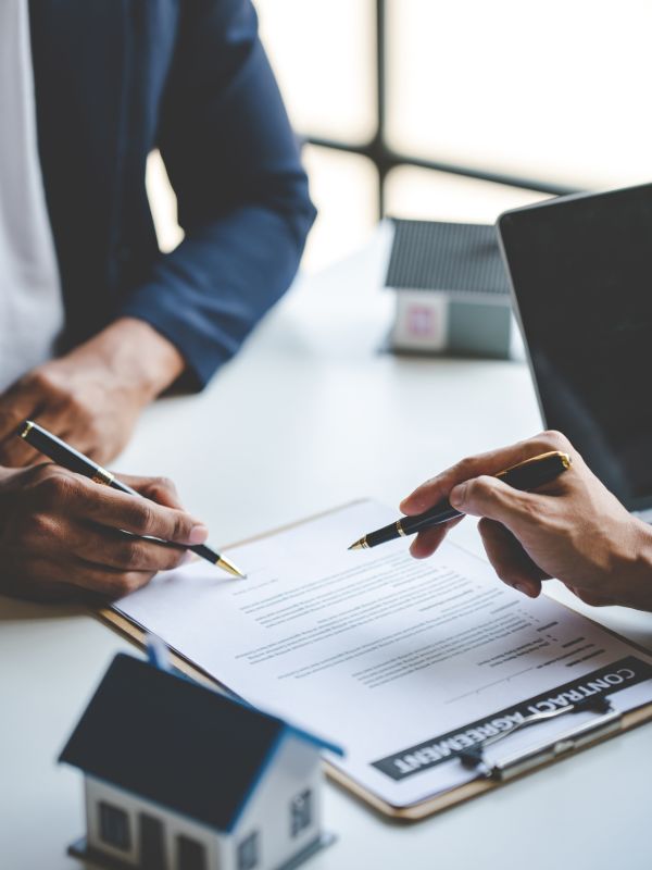 Property transaction documents being reviewed during a client meeting