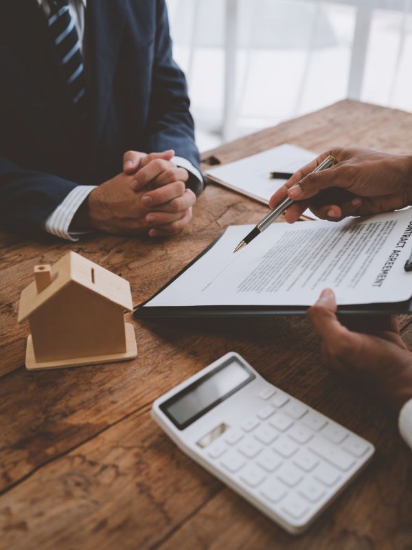 Real estate professionals reviewing property documents and contracts
