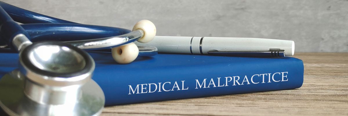 Medical malpractice case review with legal documents and medical equipment.