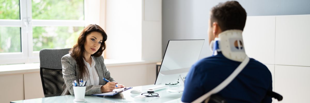 Workplace accident lawyer consulting with an injured worker.